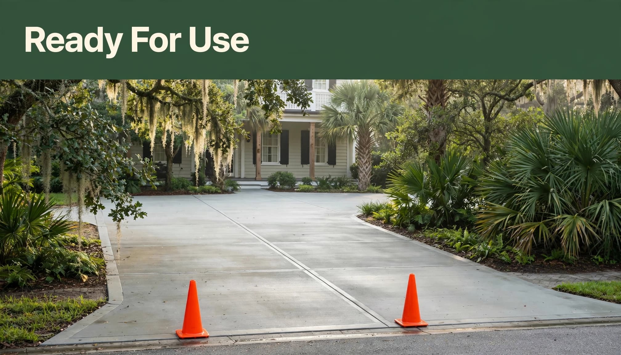 Orange cones block a new concrete driveway beneath a green headline band.